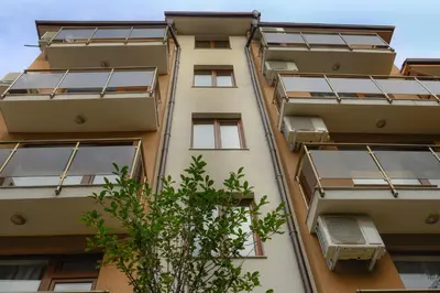 an apartment building with solar panels on the facade at Hotel Leda in Sofia