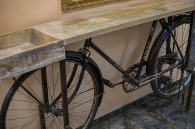 a bike is parked next to a table at Hotel Leda in Sofia