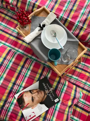 a magazine sitting on a table with a plate and a plate at Flower house 4 in Sofia