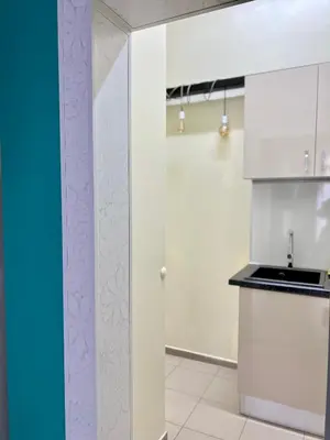 a kitchen with white cabinets and a sink at Flower house 4 in Sofia