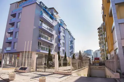 a tall building with a fence in front of it at Flower house 4 in Sofia