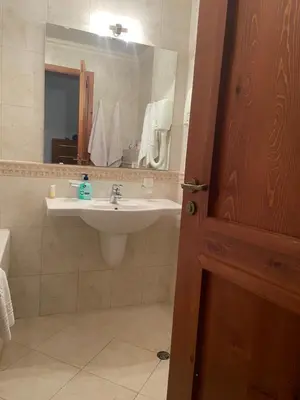 a bathroom with a sink and a mirror at Luxory aparthotel in 4 star SPA hotel st Ivan Rilski, Bansko in Bansko
