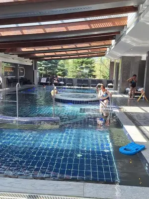 a woman in a swimming pool in a building at Luxory aparthotel in 4 star SPA hotel st Ivan Rilski, Bansko in Bansko