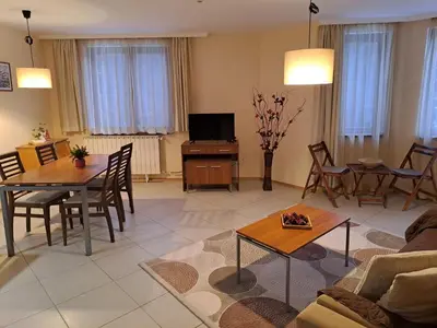 a living room with a couch and a table at Apartment 322, Villa Park in Borovets