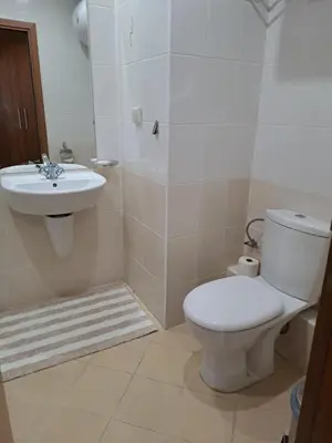 a bathroom with a toilet and a sink at Apartment 322, Villa Park in Borovets