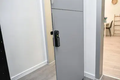 a white refrigerator in a room with a door at Duplex Condo Prime Location 2BTH 2 Studios in Sofia
