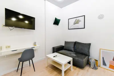 a living room with a couch and a table at Duplex Condo Prime Location 2BTH 2 Studios in Sofia