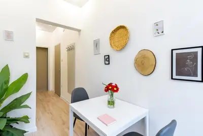 a dining room with a white table and chairs at Duplex Condo Prime Location 2BTH 2 Studios in Sofia