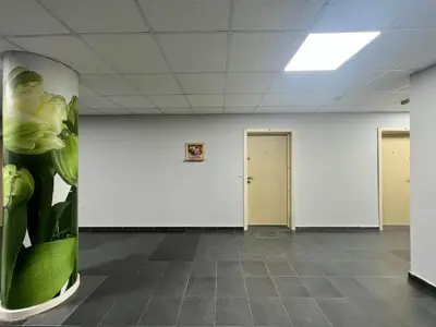 a room with white walls and a green column at Flower house 7 in Sofia