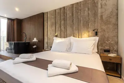 a bedroom with a large bed with towels on it at Abrazo Sofia Hotel by HMG in Sofia