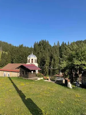 a building with a tower on top of a field at Marina apartment in Stoykite