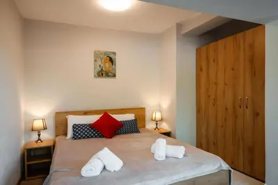 a bedroom with a bed with two towels on it at Cozy Apartment Green Terrace in Plovdiv