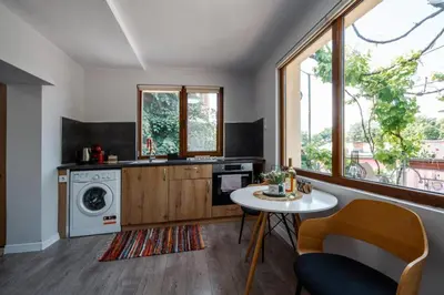 a kitchen with a table and a washing machine at Cozy Apartment Green Terrace in Plovdiv