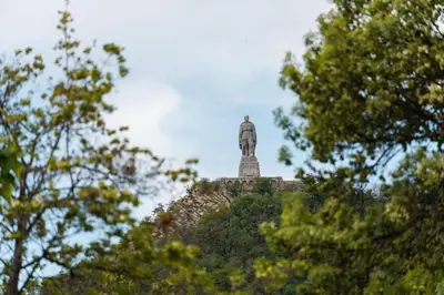 a statue on top of a hill with trees at Cozy Apartment Green Terrace in Plovdiv