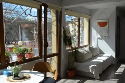 a living room with a couch in front of a window at Cozy Apartment Green Terrace in Plovdiv