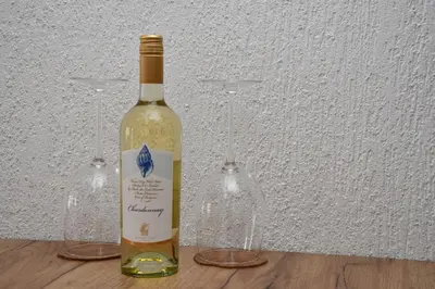 a bottle of wine sitting next to two wine glasses at Comfort 37 - Luxury ski apartment near the gondola in Bansko