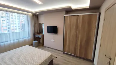 a hotel room with a bed and a sliding glass door at Апартамент Relax in Smolyan
