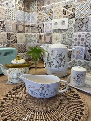 a table with a tea pot and a cup on a basket at Boutique apartment Bansko Bell Tower in Bansko