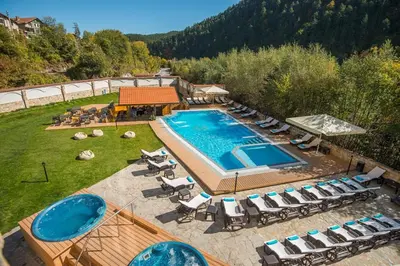 an aerial view of a swimming pool with lounge chairs and a swimming pool at Мия 2 Спа хотел Свети Спас in Velingrad