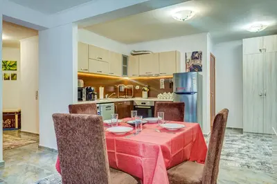a dining room with a table and chairs and a kitchen at Bright and Spacious 2-BDR Apartment with Balcony by Flat Mаnager in Pamporovo