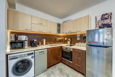 a kitchen with a refrigerator and a washer and dryer at Bright and Spacious 2-BDR Apartment with Balcony by Flat Mаnager in Pamporovo