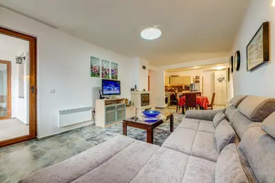 a living room with a couch and a table at Bright and Spacious 2-BDR Apartment with Balcony by Flat Mаnager in Pamporovo