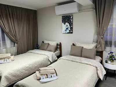 a bedroom with two beds with trays on them at Guest House Tatiana Studio in Petrich