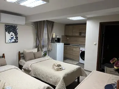 a small room with two beds and a kitchen at Guest House Tatiana Studio in Petrich