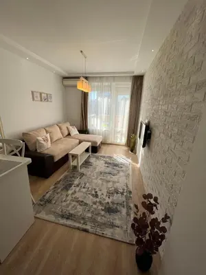 a living room with a couch and a table at Апартамент Ламартин- в сърцето на Пловдив in Plovdiv