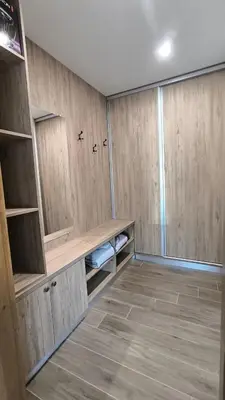 a large room with wooden cabinets and a tile floor at Къщи за гости Авена и Авена 2 in Banya