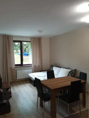 a bedroom with a bed and a table and chairs at Apartment E23 Borovets Gardens in Borovets