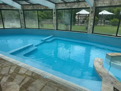 a large swimming pool with clear blue water at Мия 3 Спа хотел Свети Спас in Velingrad