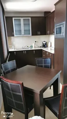 a kitchen with a table and chairs in a kitchen at Apartment Sam in Grand Monastery in Pamporovo