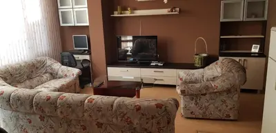 a living room with two couches and a tv at Слънчев апартамент с прекрасна гледка, паркинг. in Smolyan