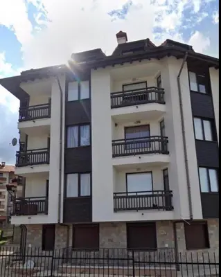 a tall building with balconies on the side of it at Jordan Apartment’s Bansko in Bansko