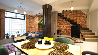 a room with a table and chairs and a brick wall at Modern and Spacious 3-Bedroom Entire House in Sofia