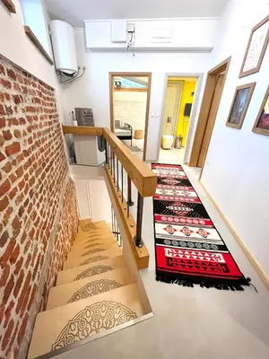 a staircase in a house with a brick wall at Modern and Spacious 3-Bedroom Entire House in Sofia