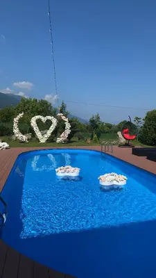a large blue swimming pool with two slides in it at Villa Manevi in Yavornitsa