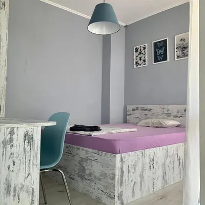 a bedroom with a purple bed and a blue chair at Blue loft & 2bedrooms & parking in Sofia