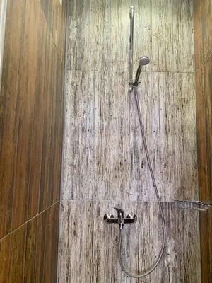a shower in a bathroom with a wooden floor at Blue loft & 2bedrooms & parking in Sofia