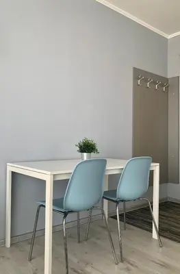 a table with two chairs and a potted plant on it at Blue loft & 2bedrooms & parking in Sofia