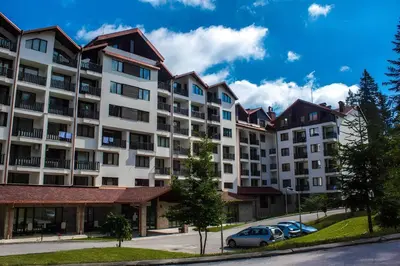 an apartment building with cars parked in a parking lot at NEAT STUDIOS in 