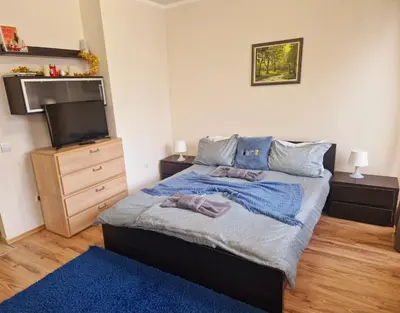 a bedroom with a bed and a flat screen tv at NEAT STUDIOS in 
