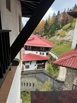 a view of a building with a red roof at Grand Monastery Apartment in Pamporovo