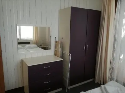 a bedroom with a mirror and a dresser and a bed at Grand Monastery Apartment in Pamporovo