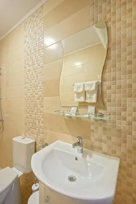 a bathroom with a sink and a toilet and a mirror at Комплекс Колонада in Hisarya