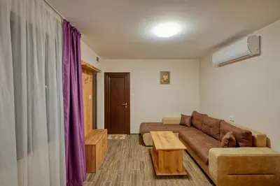a living room with a couch and a coffee table at Комплекс Колонада in Hisarya