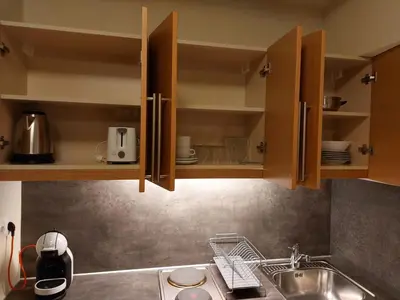 a kitchen with wooden cabinets and a sink at Residence E205 Euphoria Borovets in Borovets