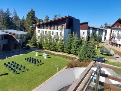 an aerial view of a building with a lawn with chairs at Residence E205 Euphoria Borovets in Borovets