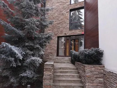 a brick house with stairs leading to a door at Residence E205 Euphoria Borovets in Borovets